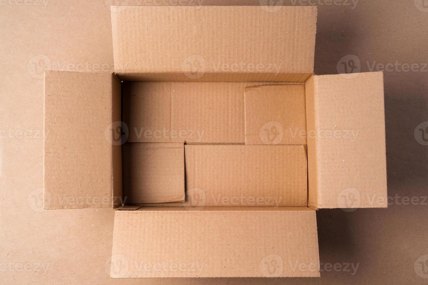 Cardboard box on beige background in studio photo