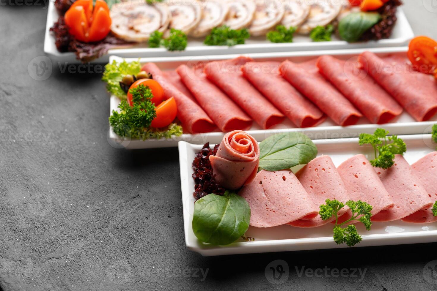 Platter of fresh meat cold cuts on table photo