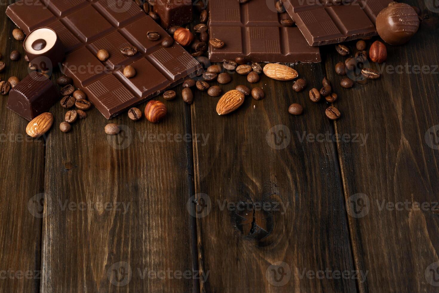 Roasted coffee beans with black chocolate close up photo
