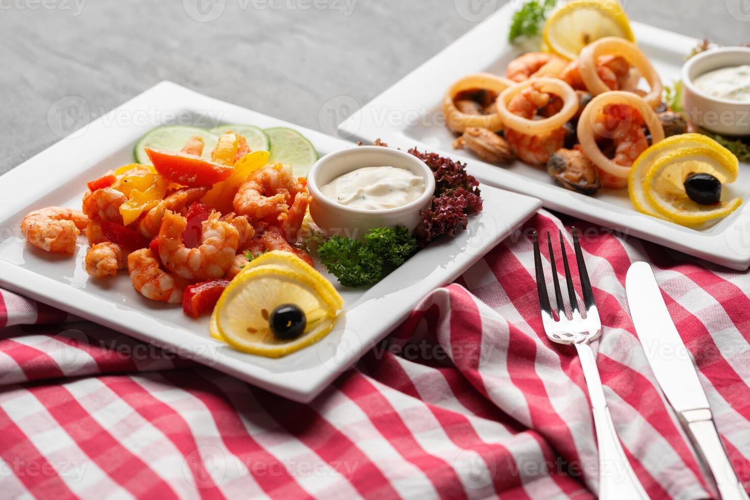 Cooked seafood on plate on gray background photo