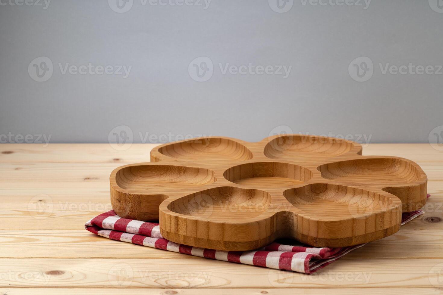 Cutting board with cotton napkin on wooden table photo