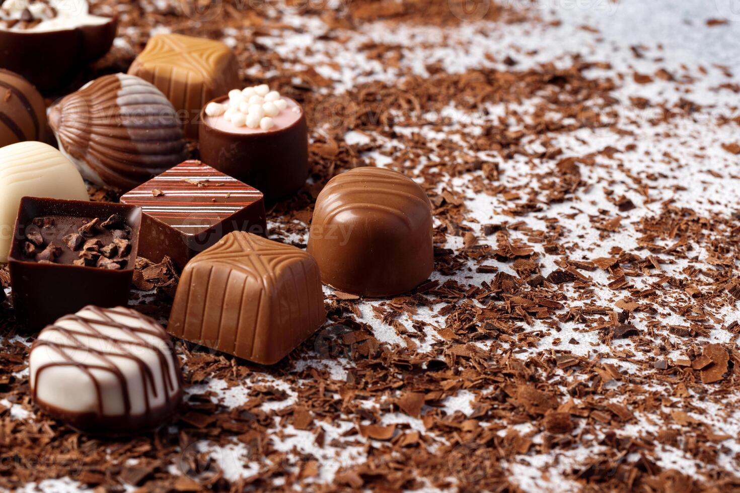 Various chocolate praline candies assortment close up photo