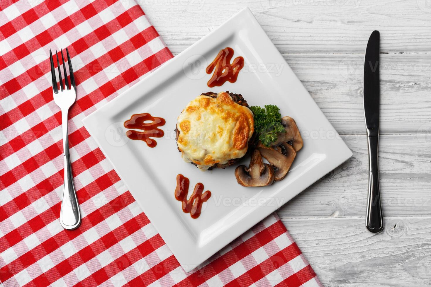 Delicious veal cutlet with melted mozzarella cheese on white plate photo