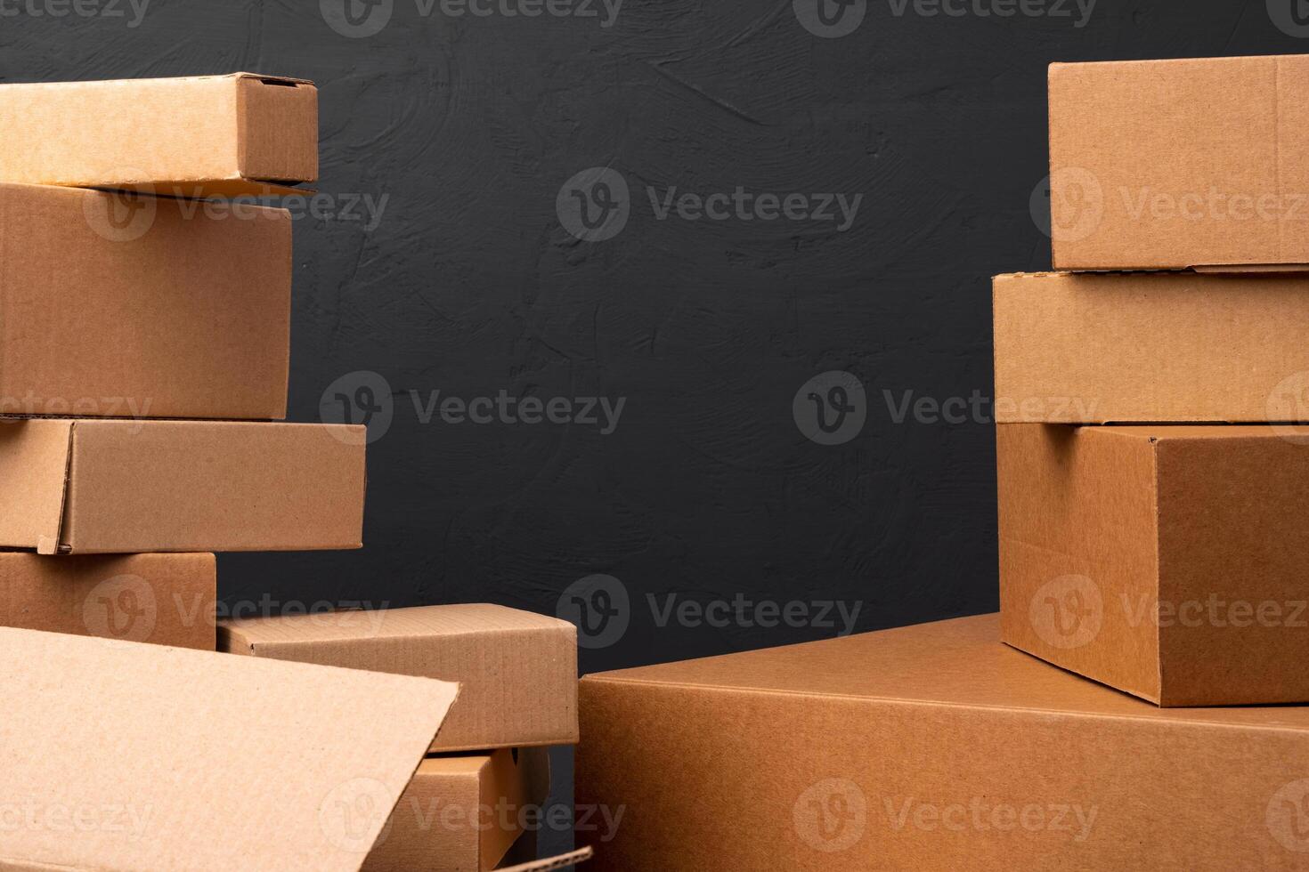 Stack of cardboard boxes against black background photo