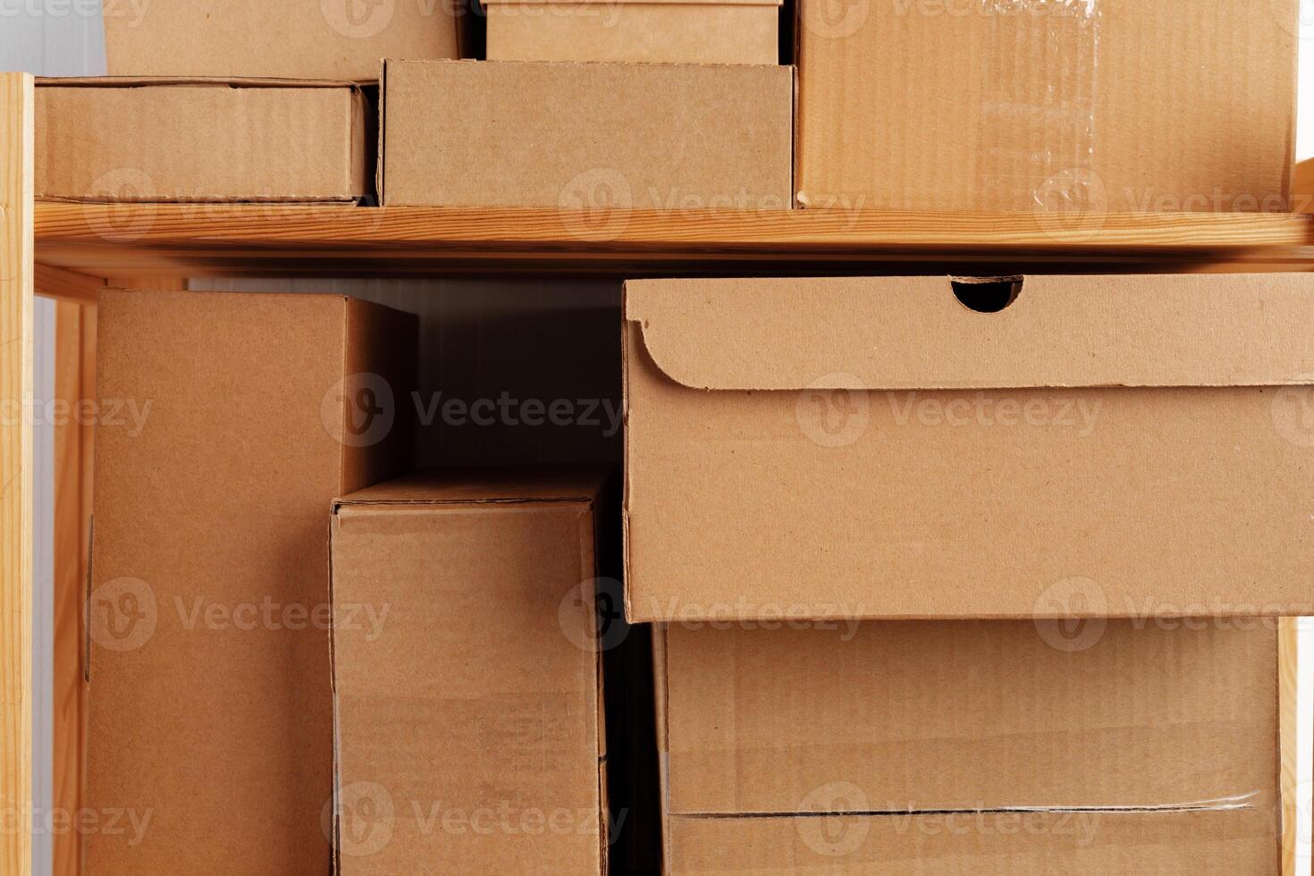 Stack of cardboard package boxes on wooden rack photo