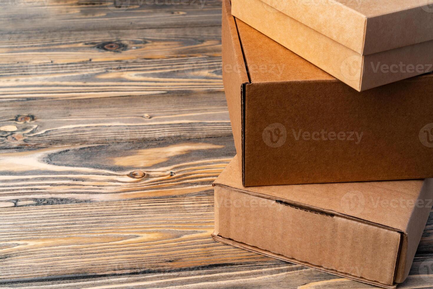 Pile of cardboard boxes on wooden background photo