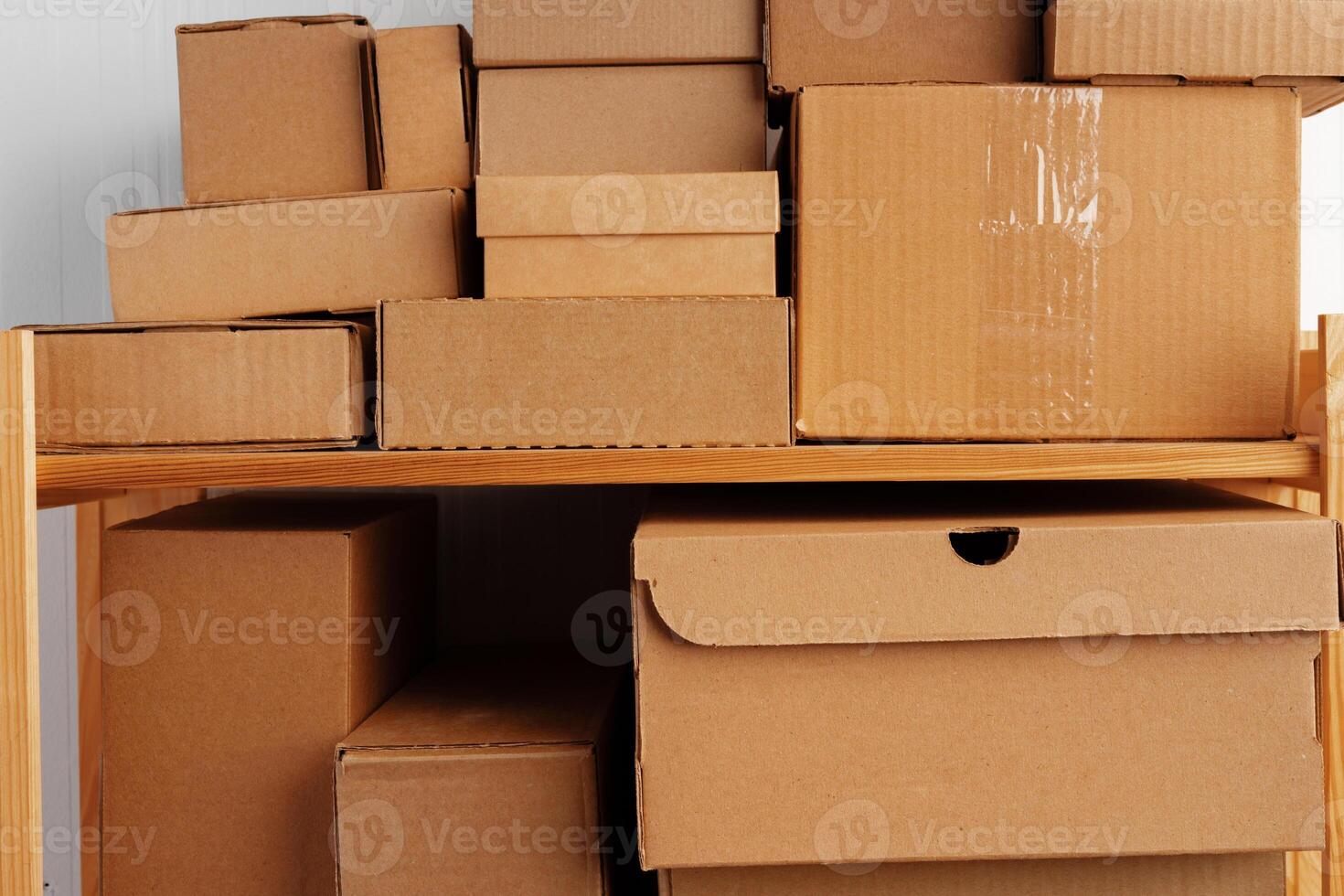 Stack of cardboard package boxes on wooden rack photo