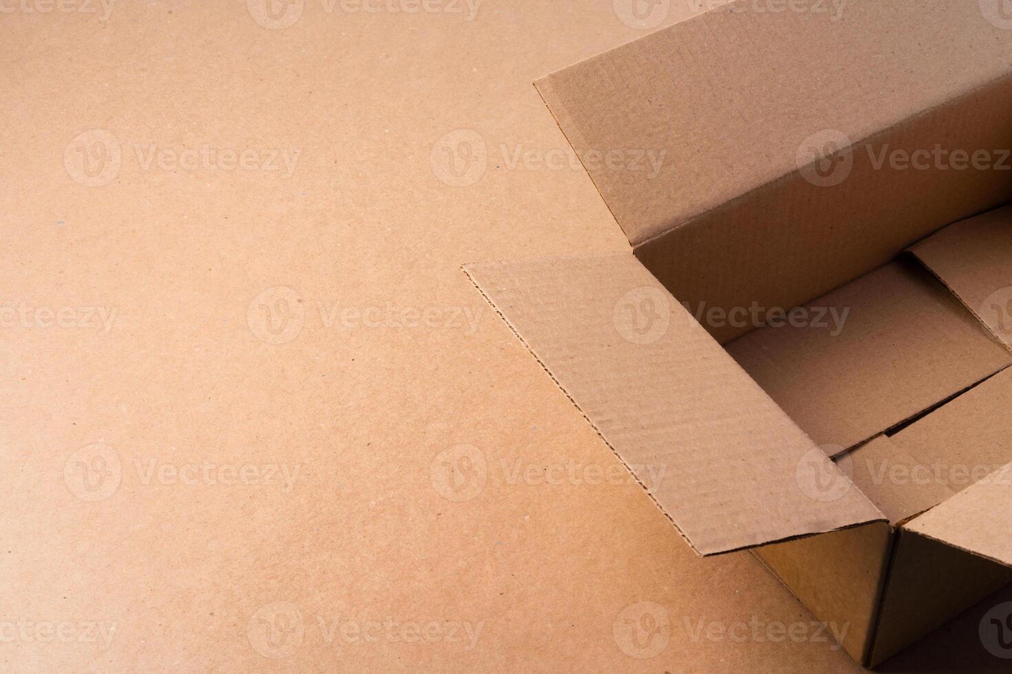 Cardboard box on beige background in studio photo