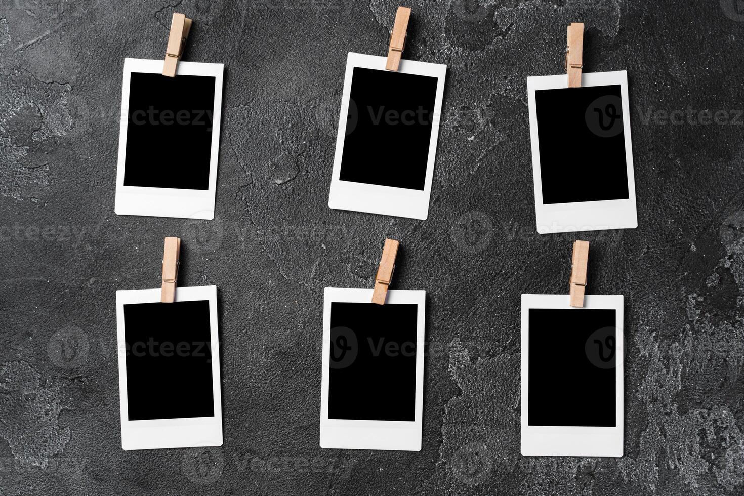 Paper photo frames with blank space on gray textured background