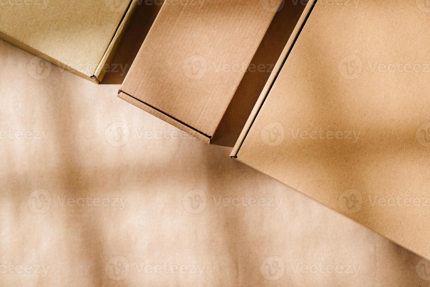 Brown cardboard boxes arranged on a neutral background in a warehouse setting during daylight hours photo
