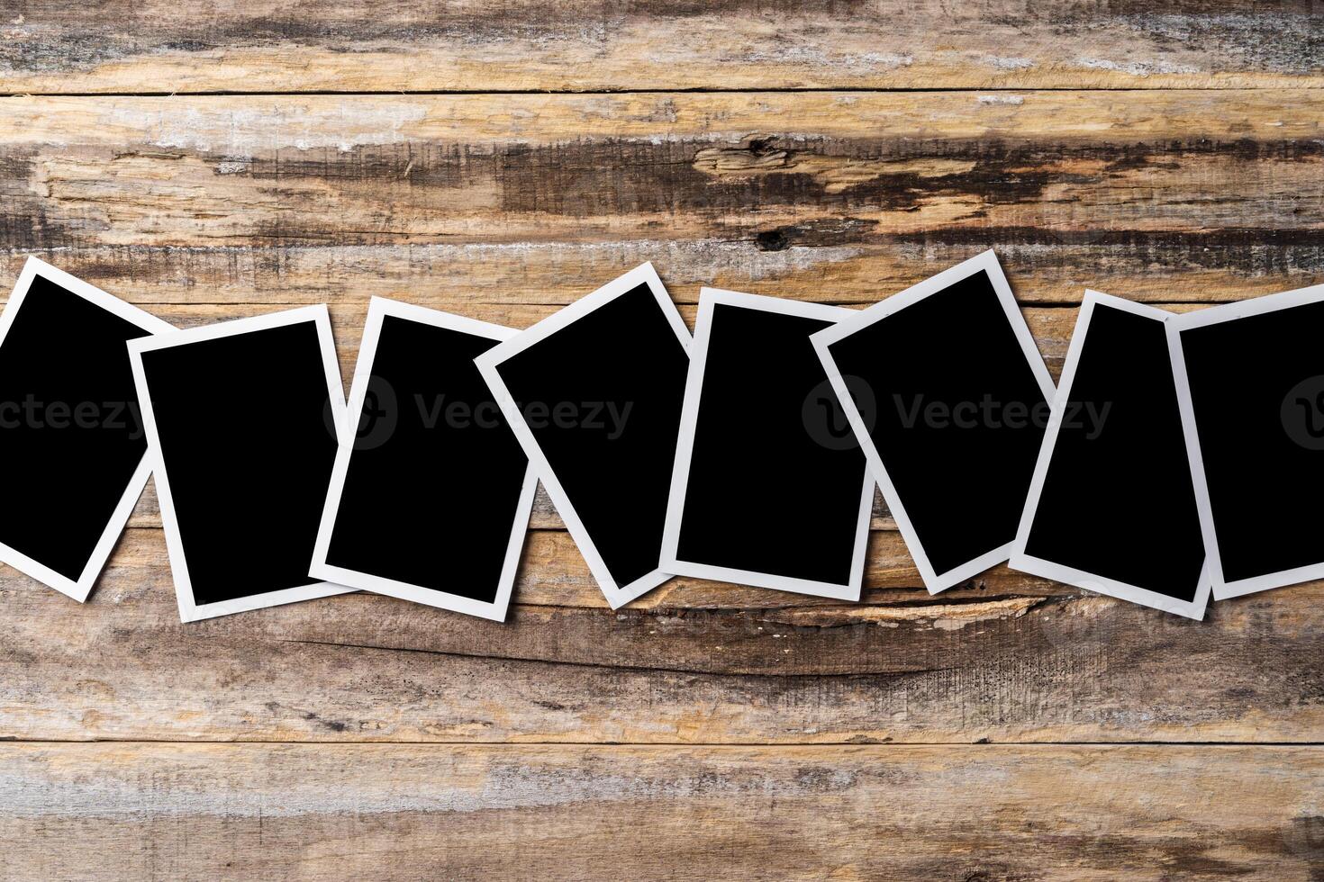 Blank photo frames for your photos on wooden background