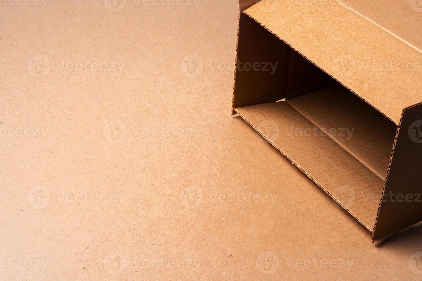 Cardboard box on beige background in studio photo