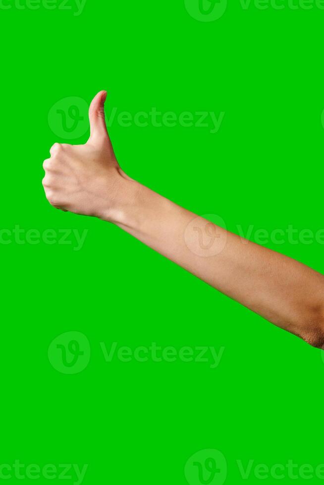 Person Giving a Thumbs Up Gesture Against a Green Screen Background photo