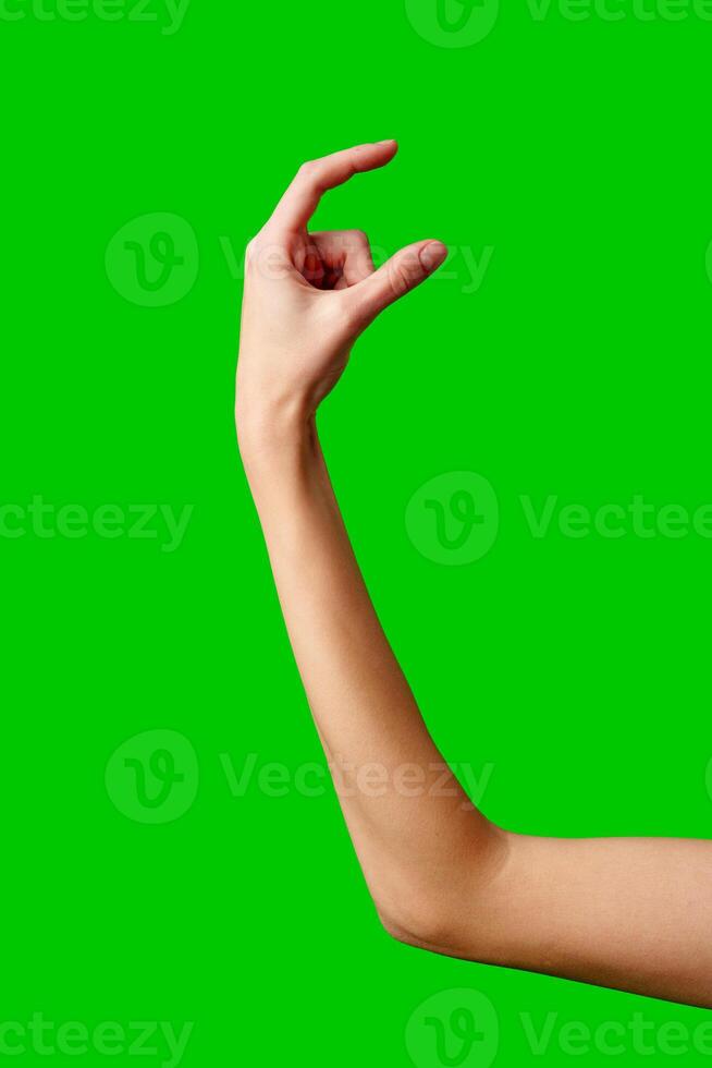 A womans hand extends upward into the air, fingers outstretched, reaching upward towards an unseen destination. photo