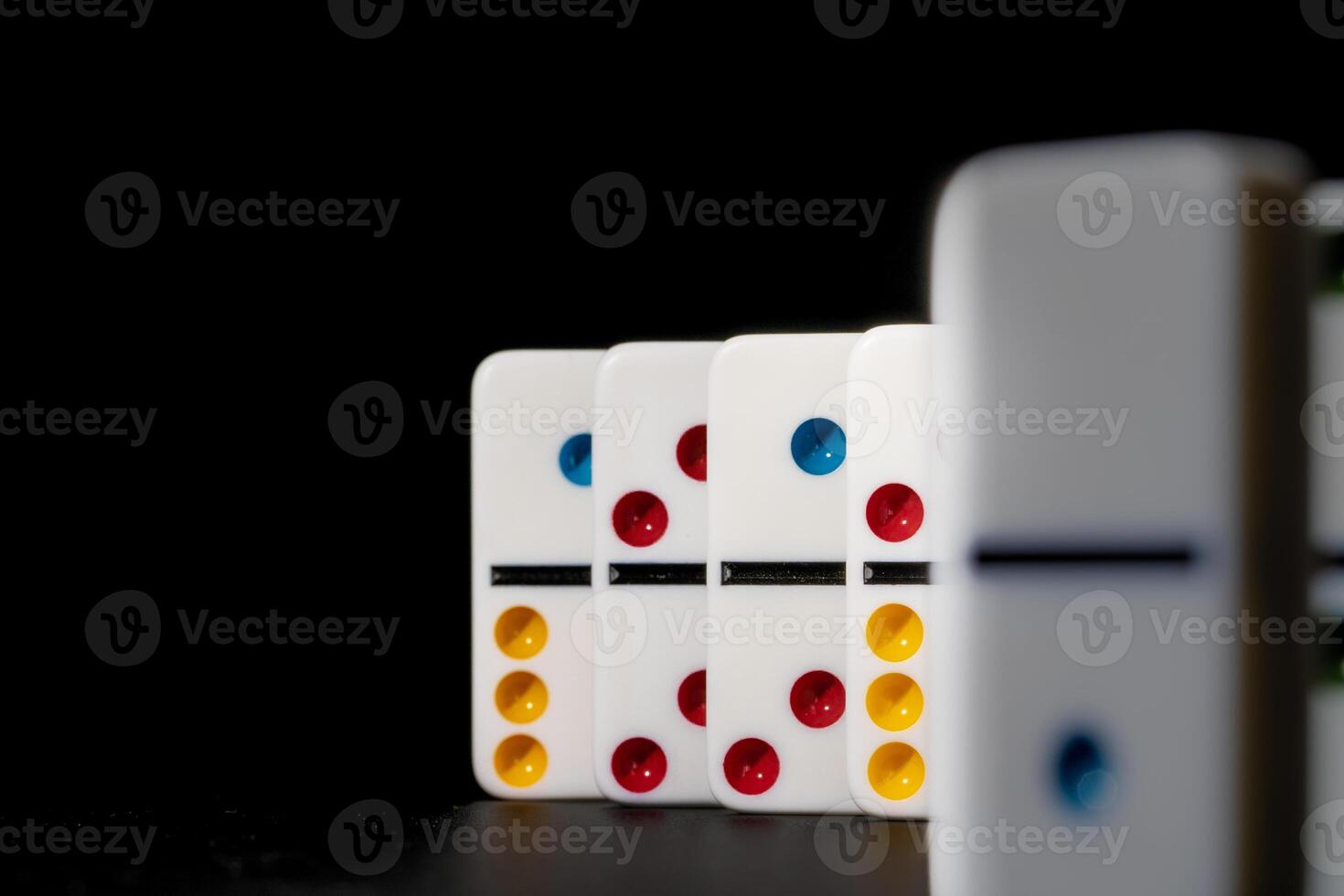 Domino game. Dominoes on a black table photo