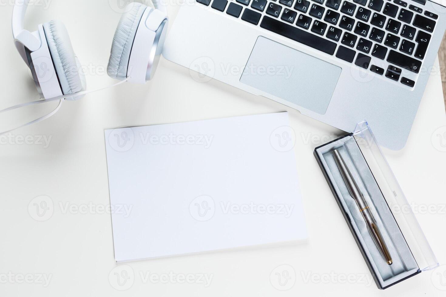 White office desk table with a lot of things on it. Top view photo