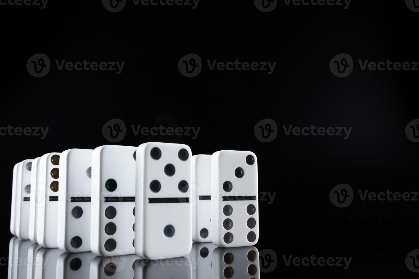 Close up of Domino pieces on black background photo