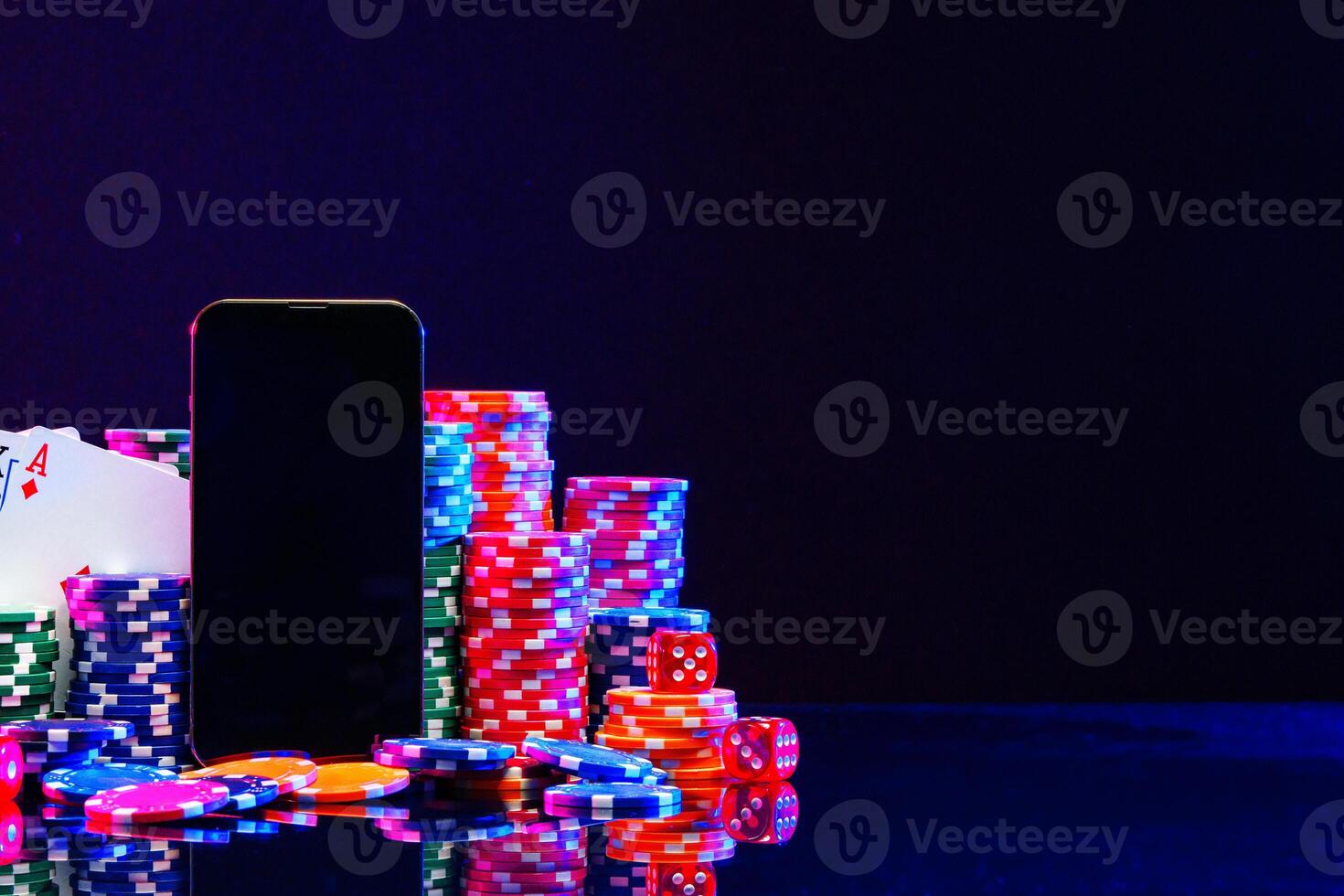 Brightly colored poker chips and playing cards arranged near a smartphone photo