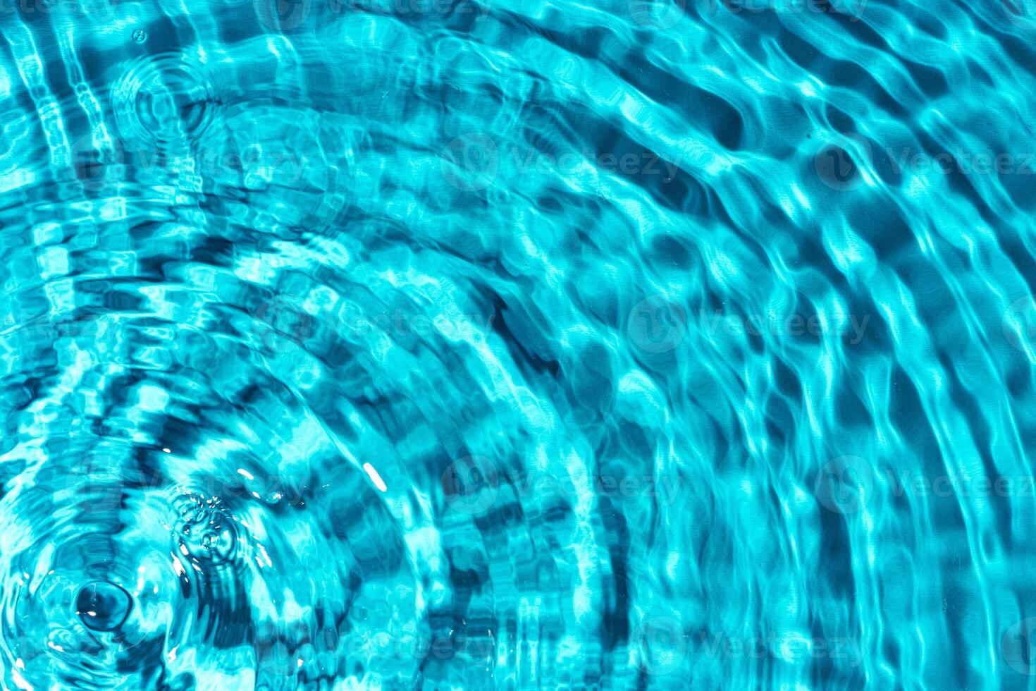 Clear turquoise pool water glistens under sunlight with gentle ripples photo