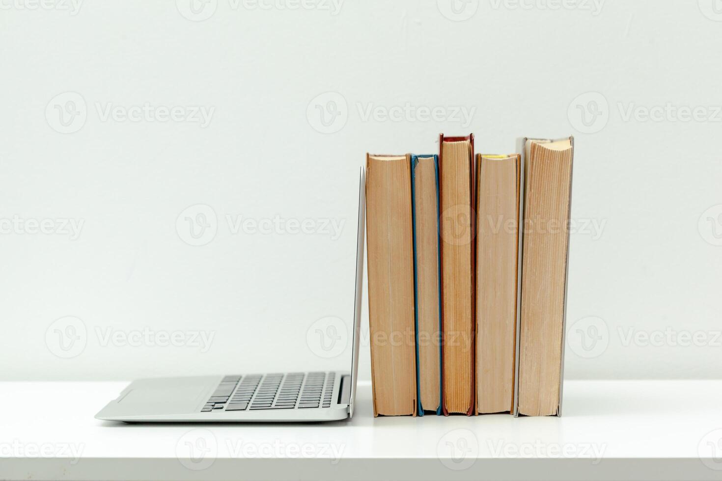 Working desk.Open laptop, books and other office supply photo