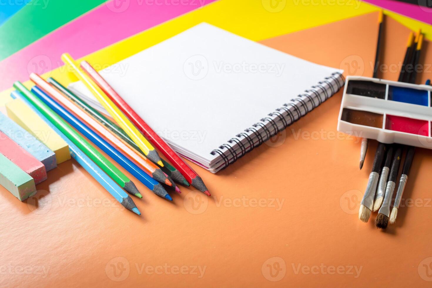 Watercolor paints set with brushes and paper sheet photo