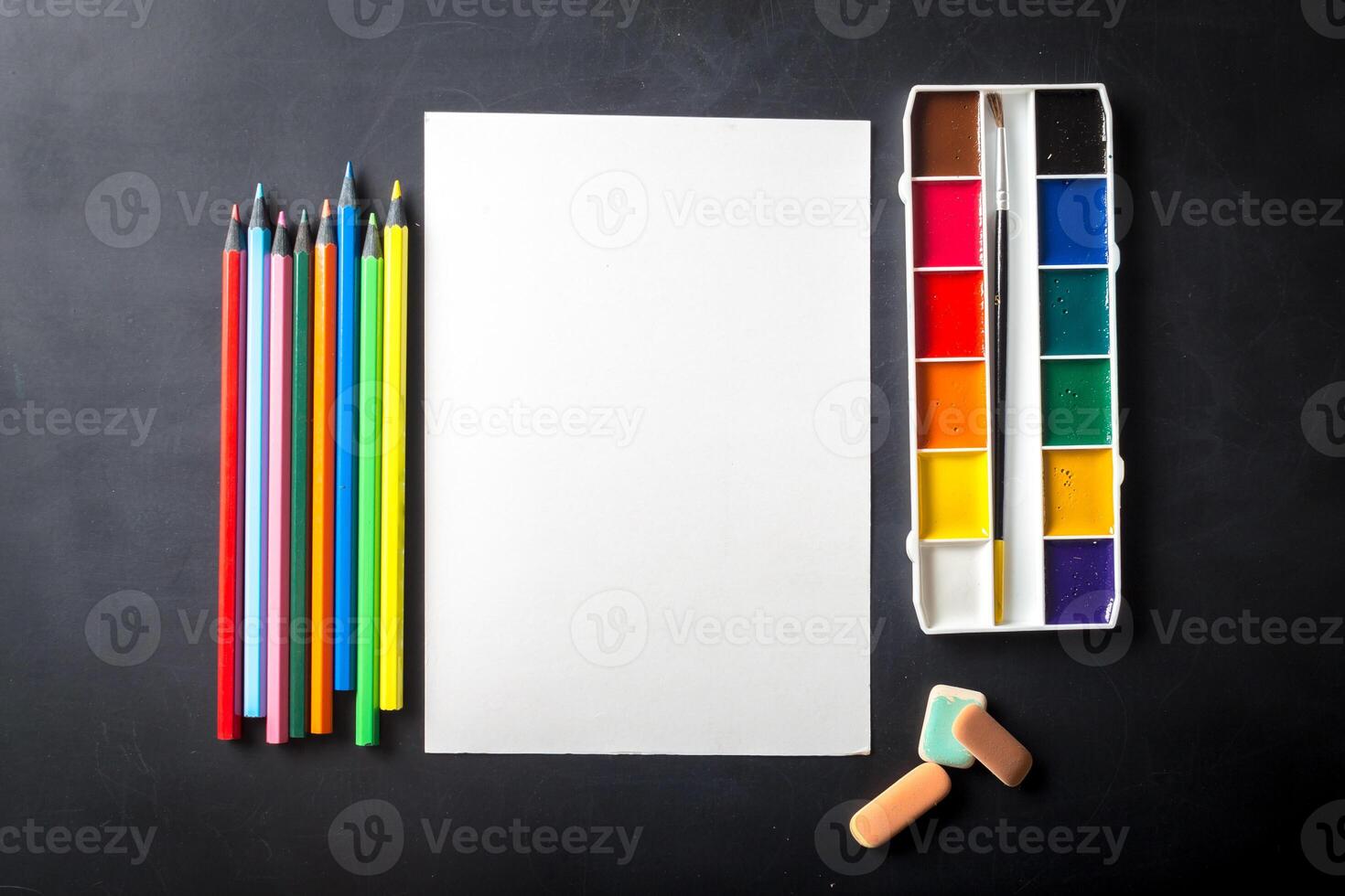 Watercolor paints set with brushes and paper sheet photo