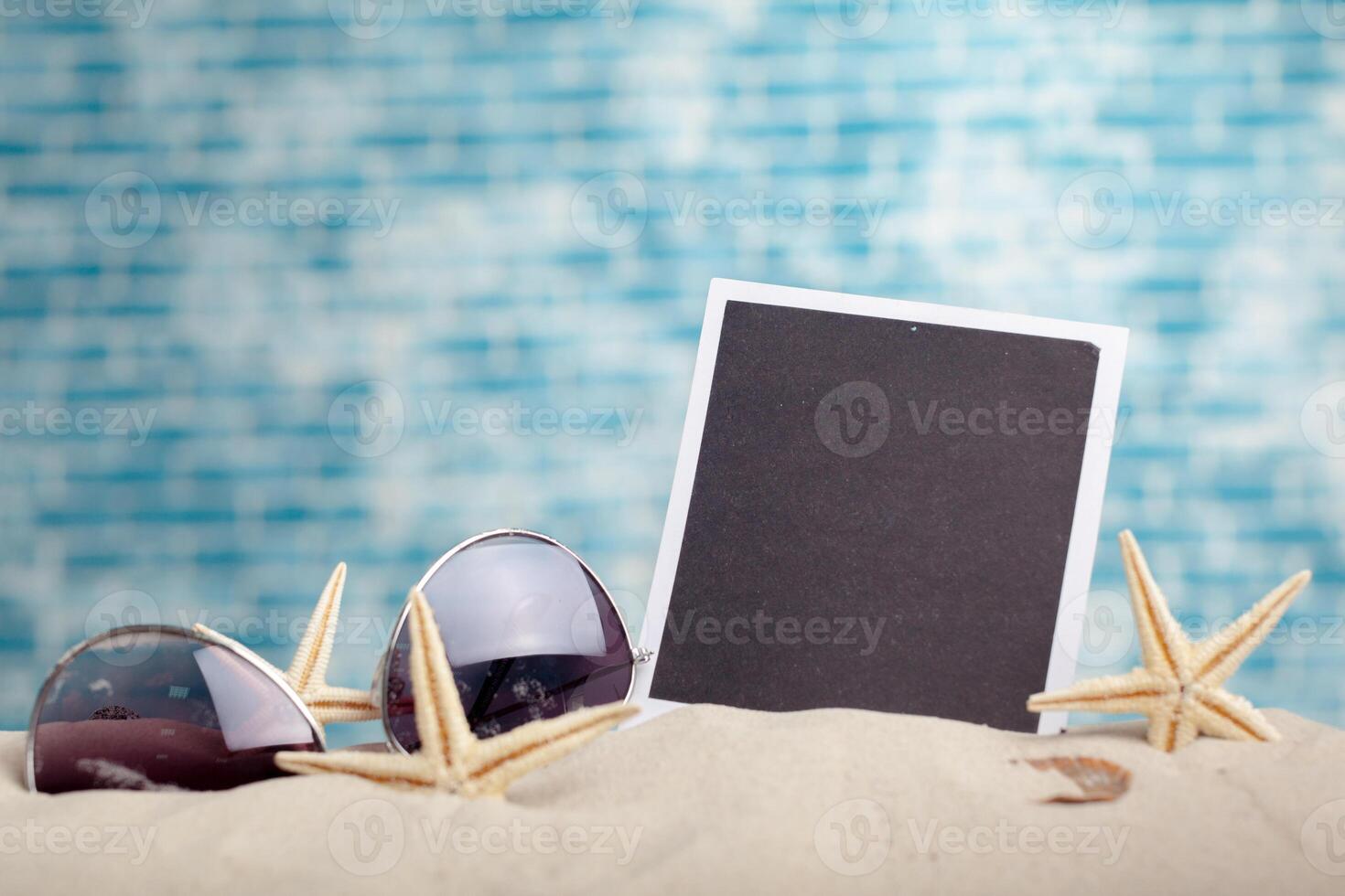 photo frames on the beach with seashells around