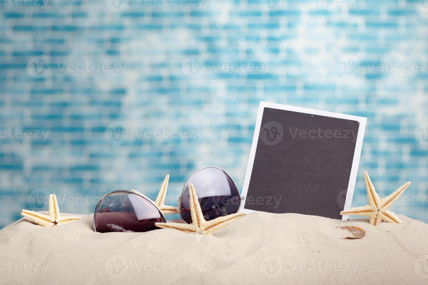 photo frames on the beach with seashells around
