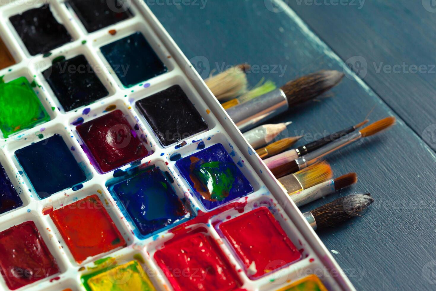Set of watercolor paints and paintbrushes for painting photo