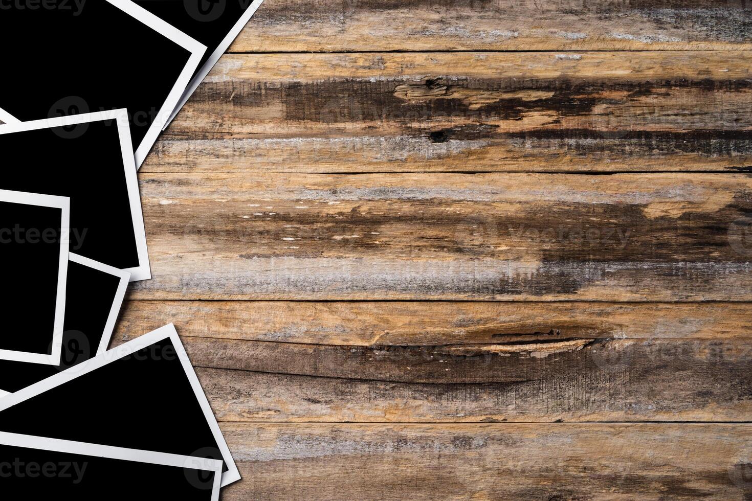 Blank photo frames for your photos on wooden background