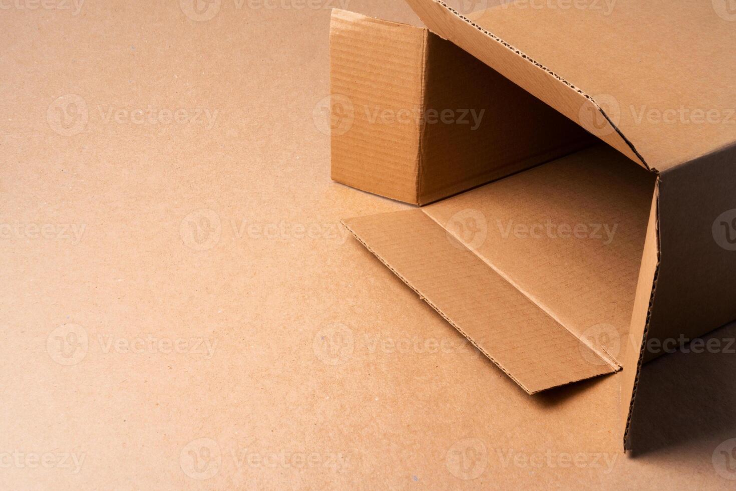 Cardboard box on beige background in studio photo
