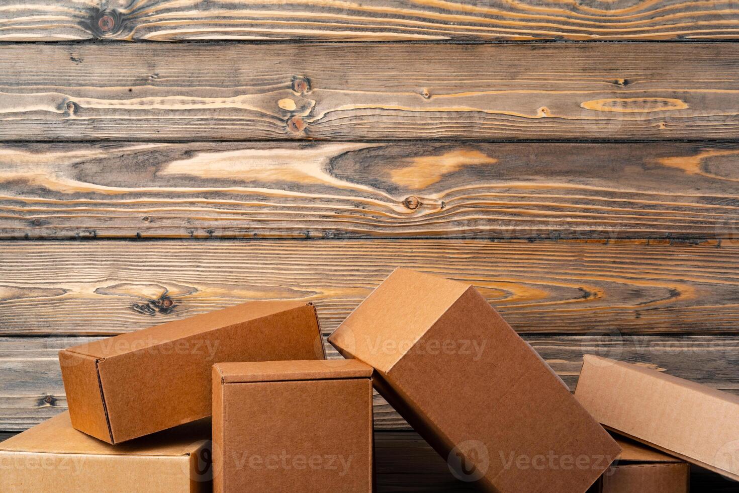 Pile of cardboard boxes on wooden background photo