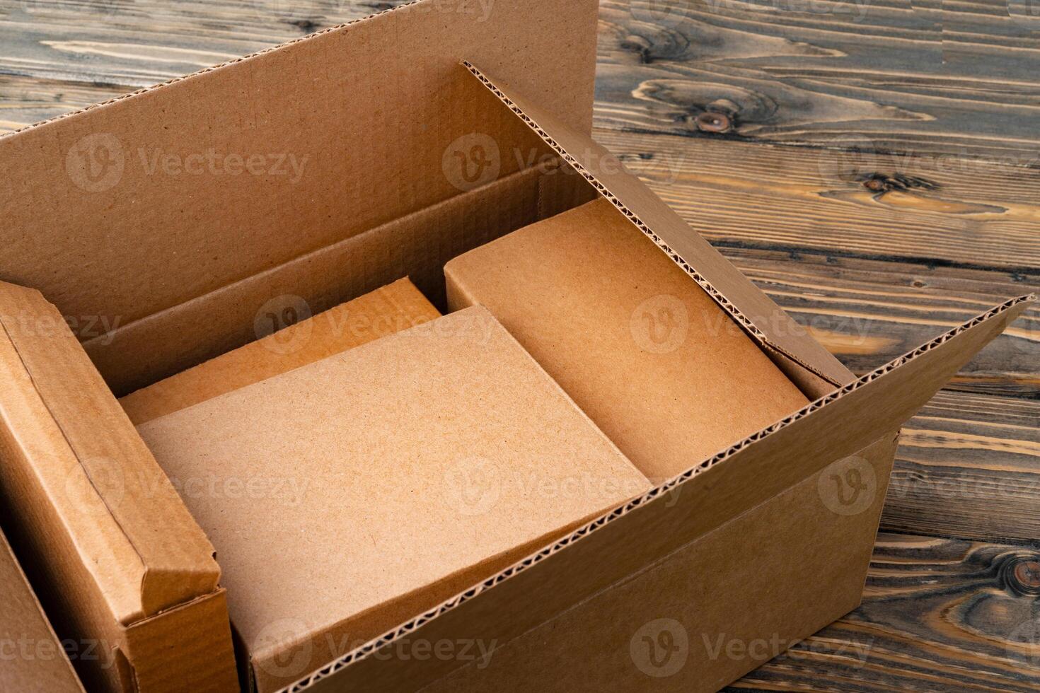 Pile of cardboard boxes on wooden background photo