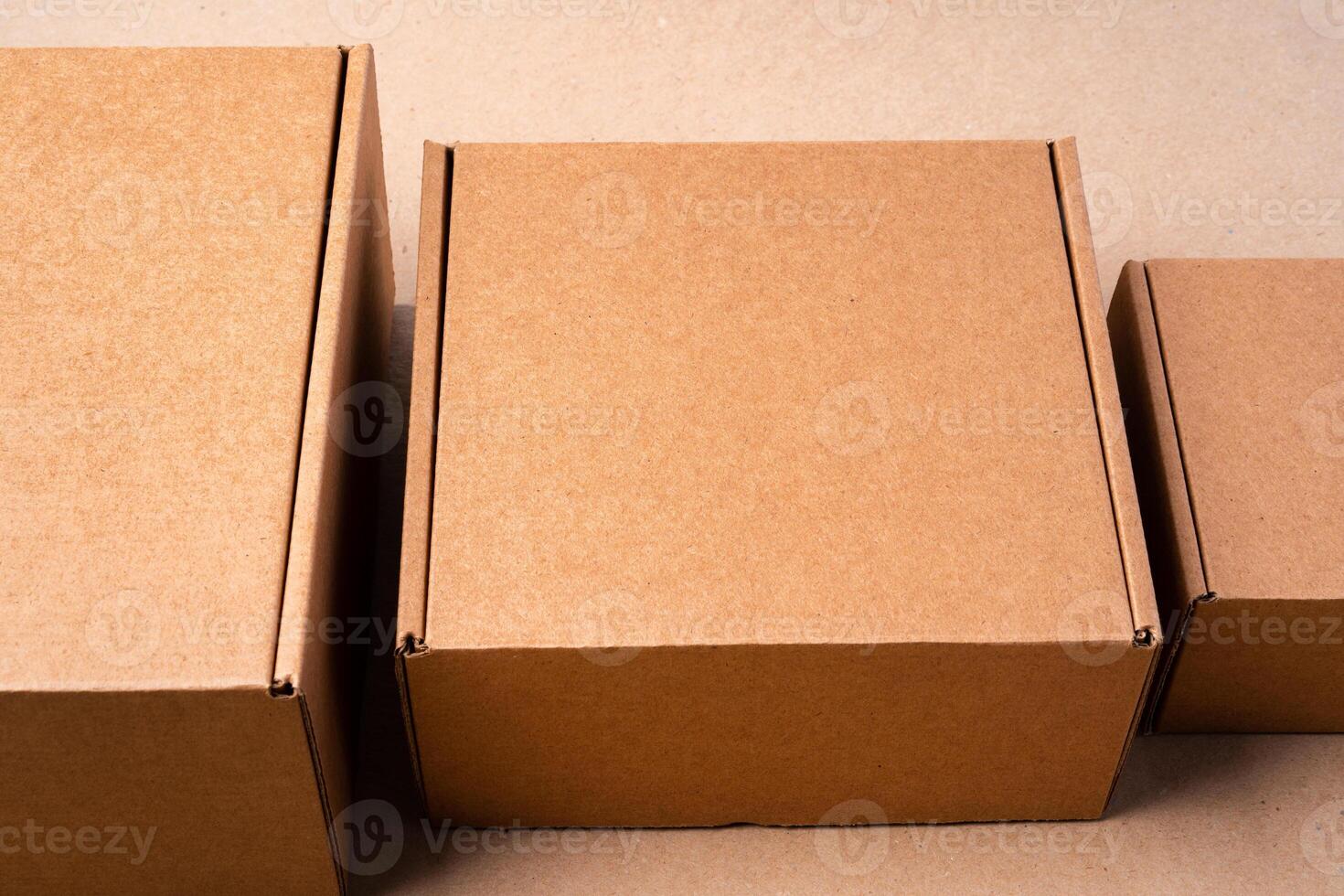 Cardboard box on beige background in studio photo