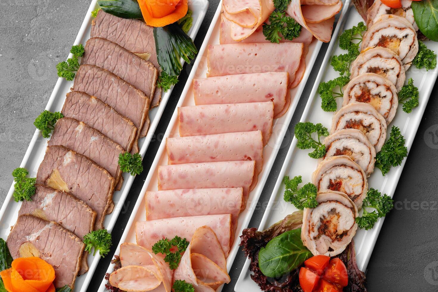 Platter of fresh meat cold cuts on table photo