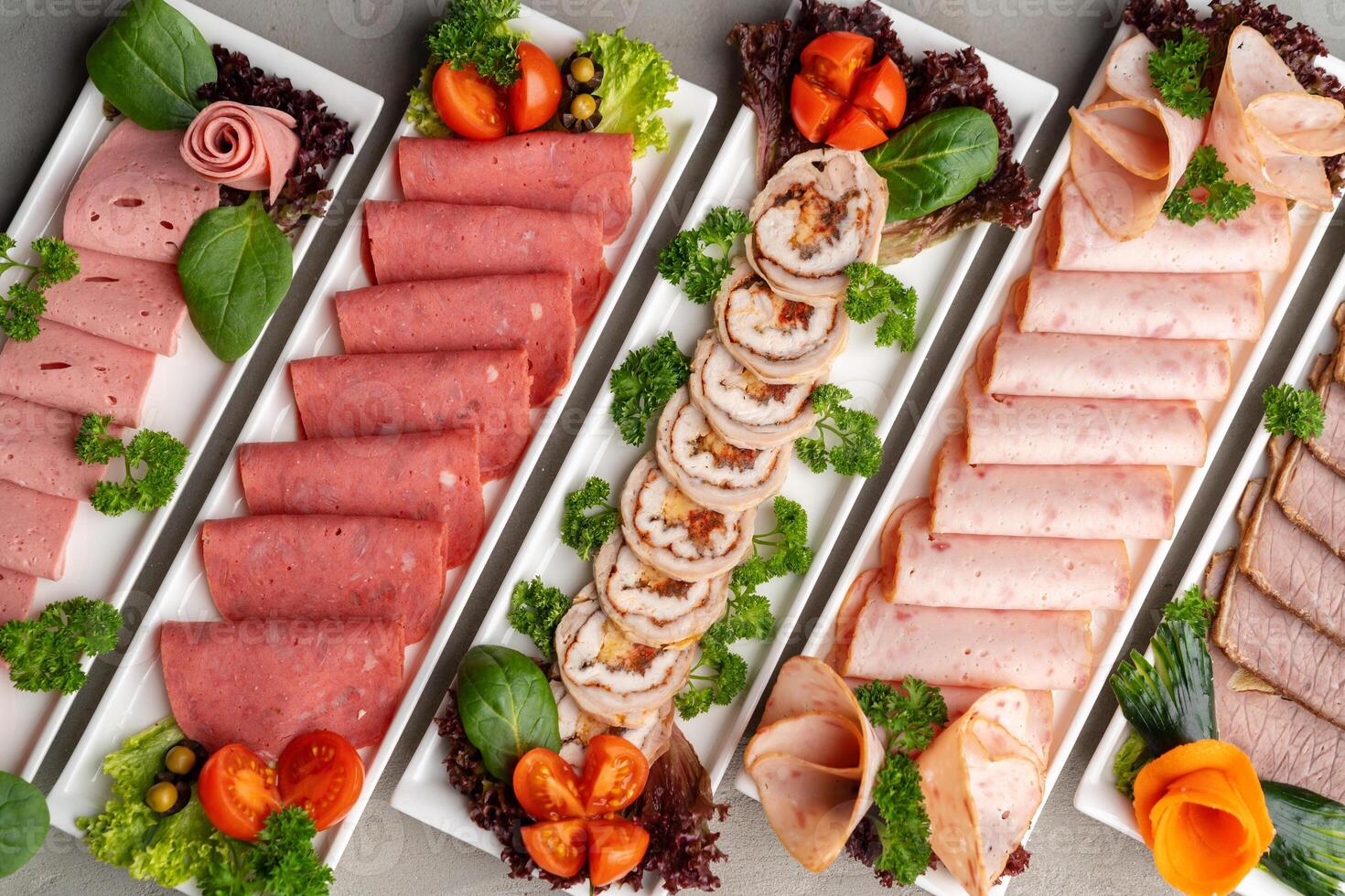 Platter of fresh meat cold cuts on table photo