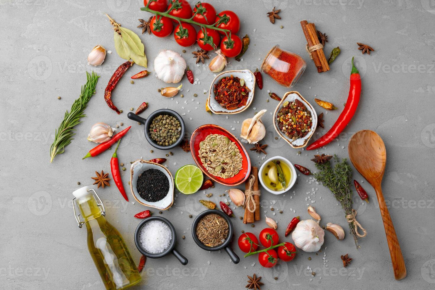 Olive oil and spices on kitchen table photo