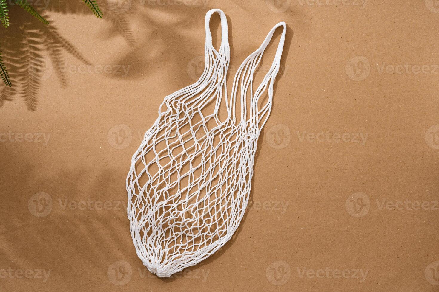 Empty string reusable bag on paper background, top view photo