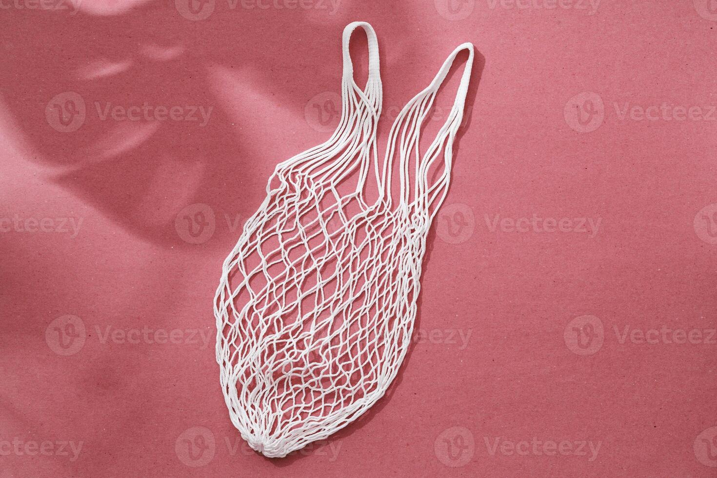 Empty string reusable bag on paper background, top view photo