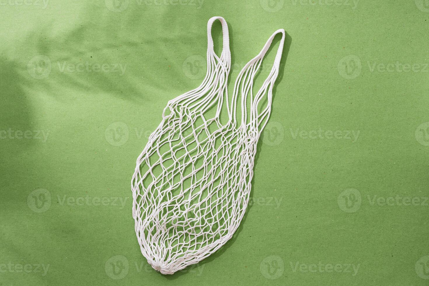 Empty string reusable bag on paper background, top view photo