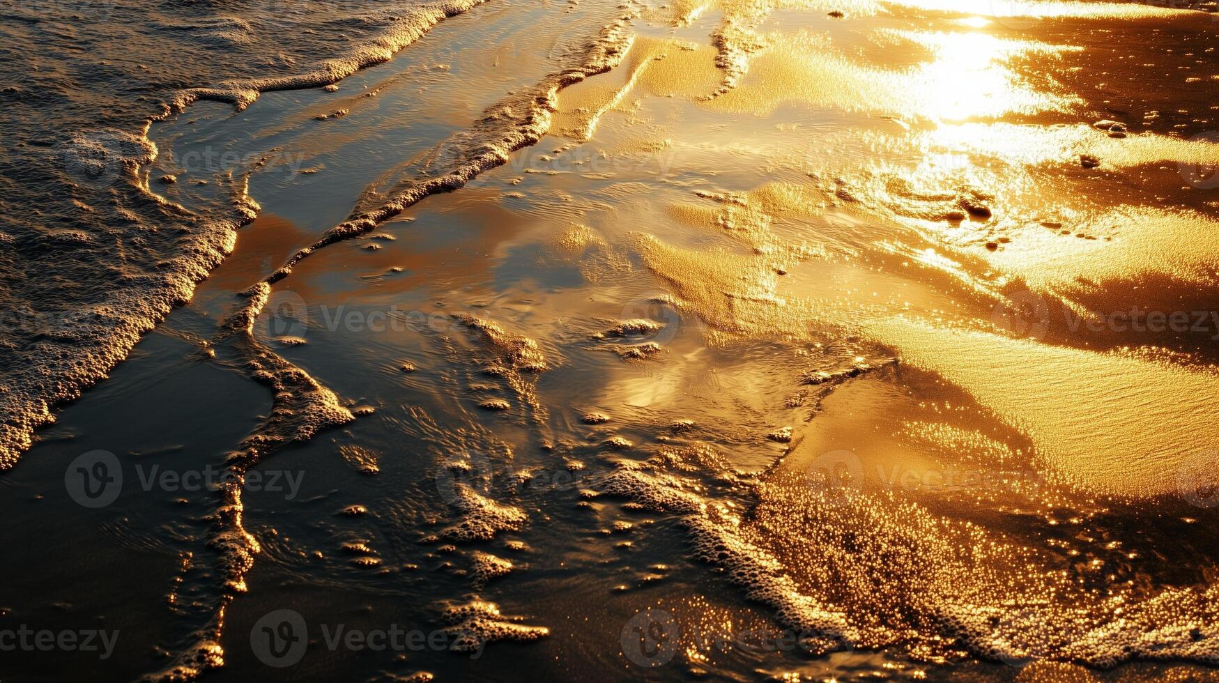 Golden sunlight reflecting on gentle ocean waves at dusk along the shoreline photo