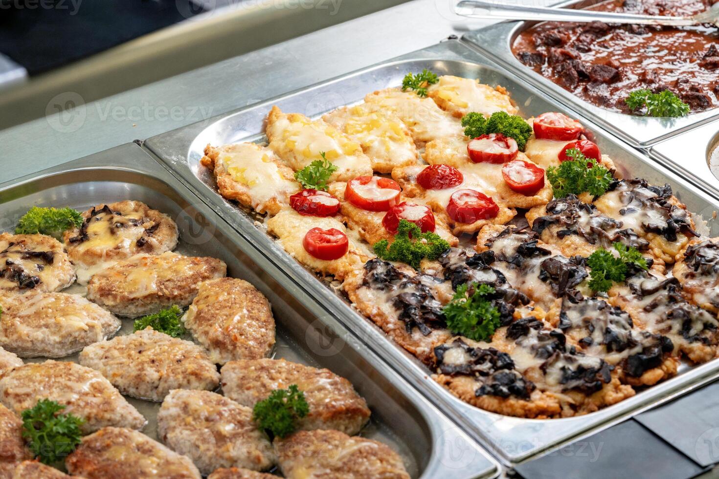 Display with fresh cooked food in a canteen photo