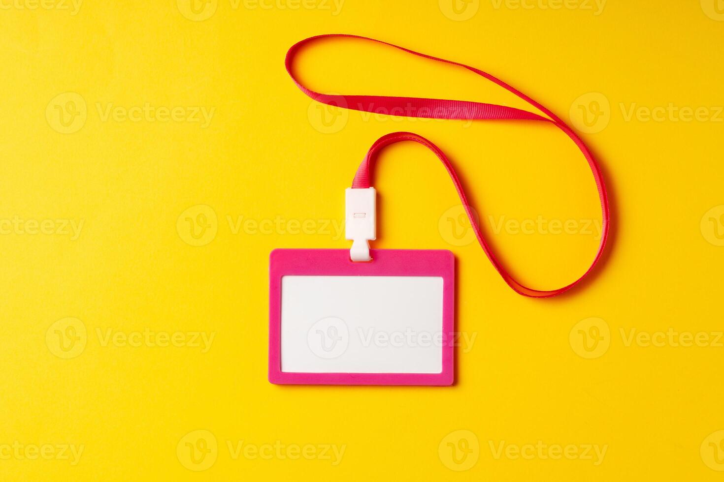 Blank nametag on a string on yellow background copy space photo