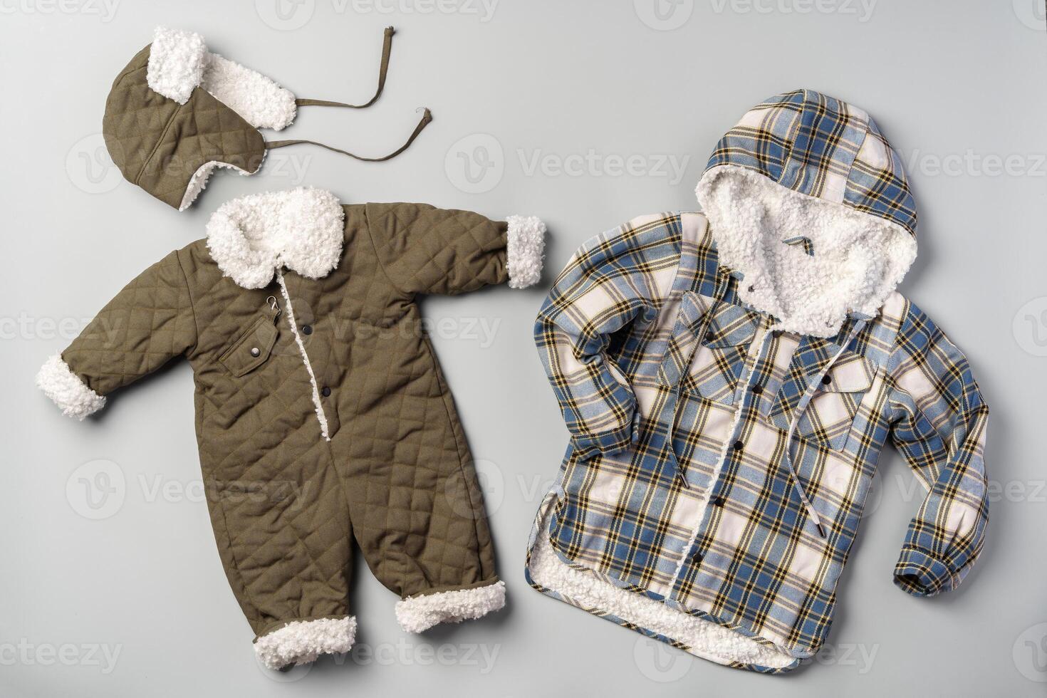 Warm baby coat for boys on gray background top view photo