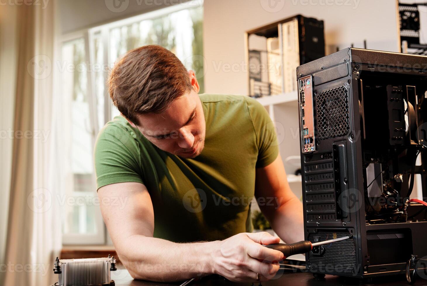 Man assembles a computer system unit at home photo