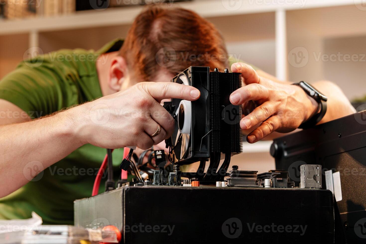 Man assembles a computer system unit at home photo