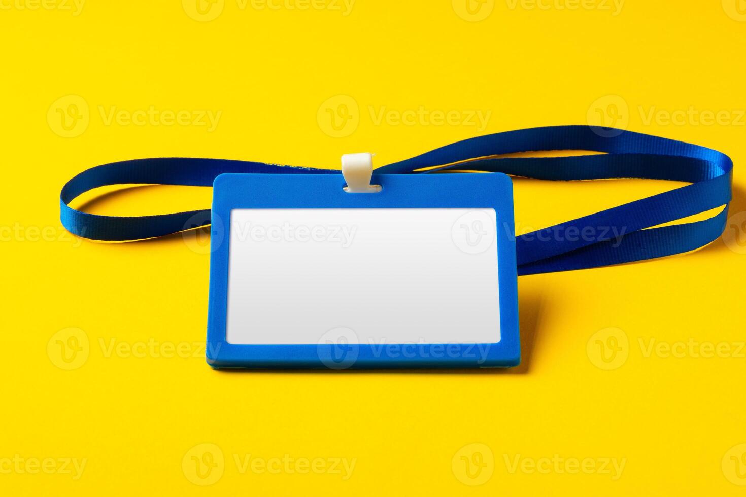 Blank nametag on a string on yellow background copy space photo