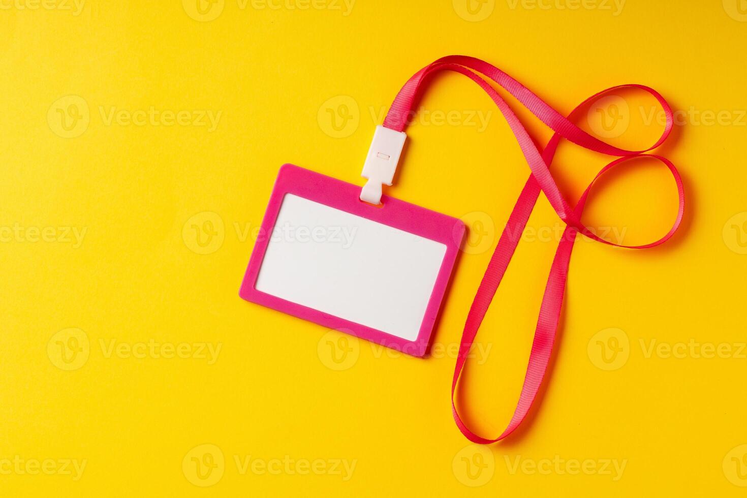 Blank nametag on a string on yellow background copy space photo