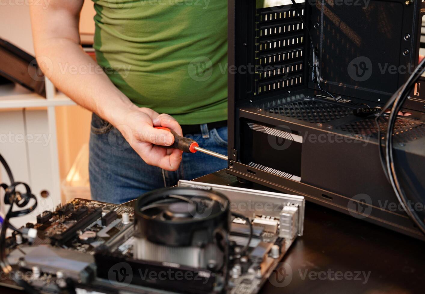 Close up of man repairing computer system unit photo