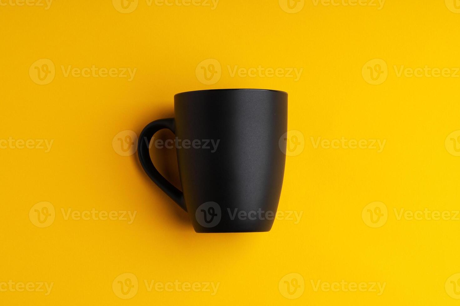 Ceramic mug on yellow studio background close up photo